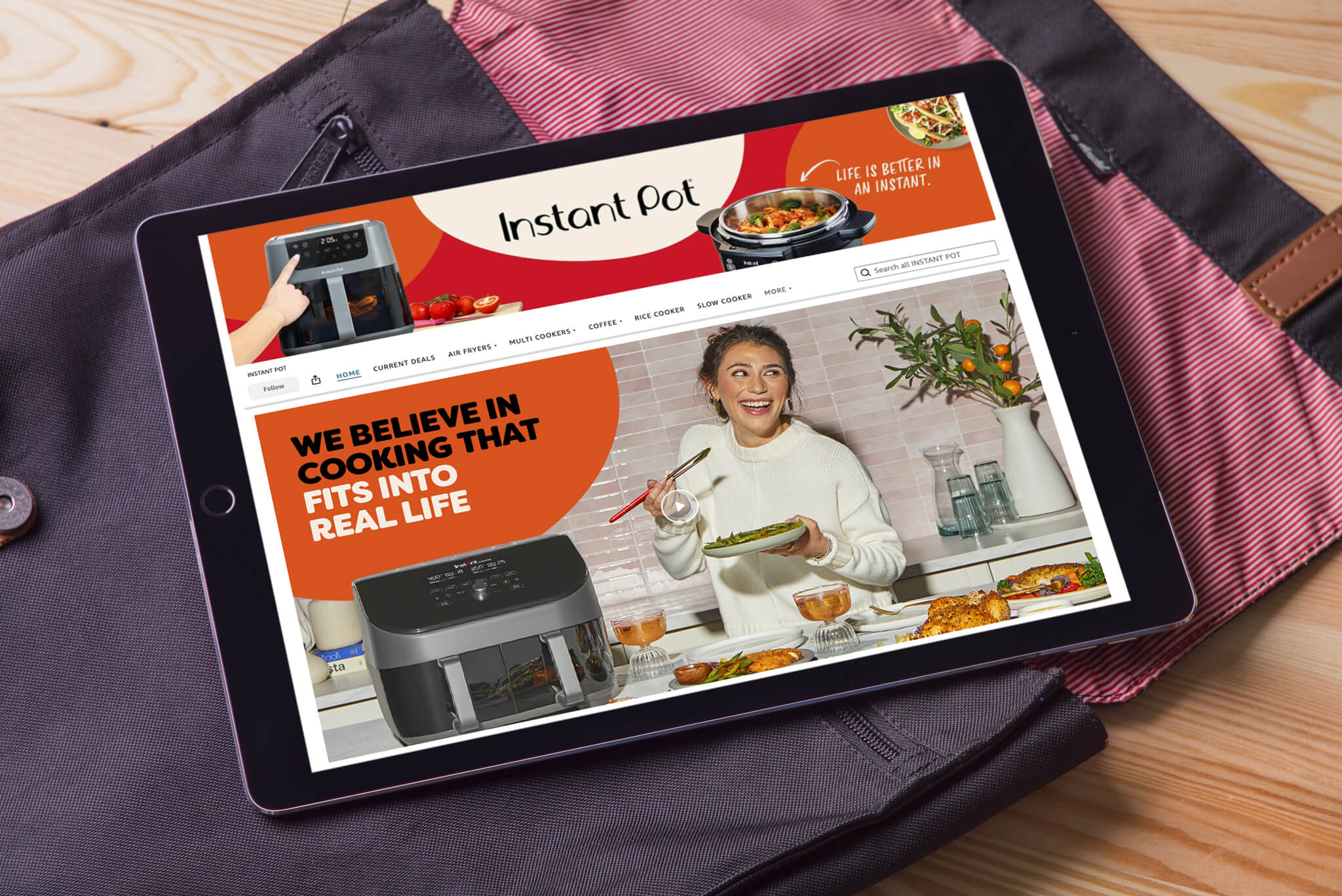 Tablet showing Instant Pot Amazon storefront with banner “We believe in cooking that fits into real life.”