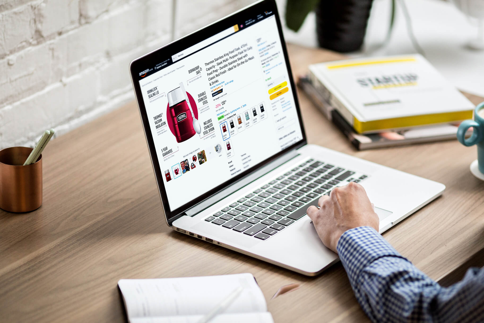 Laptop showing an Amazon product listing being reviewed for product range optimisation and pricing strategy.