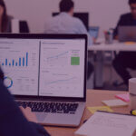 Amazon Ads incrementality dashboard in strategy meeting - Venture Forge Advertising Manager reviewing an Amazon Ads incrementality dashboard on a laptop during a strategy meeting, showing AMC analytics