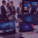 Team reviewing Amazon Ads dashboards on multiple screens, showing streaming TV creatives, audience data and AI optimisation insights in a modern office.