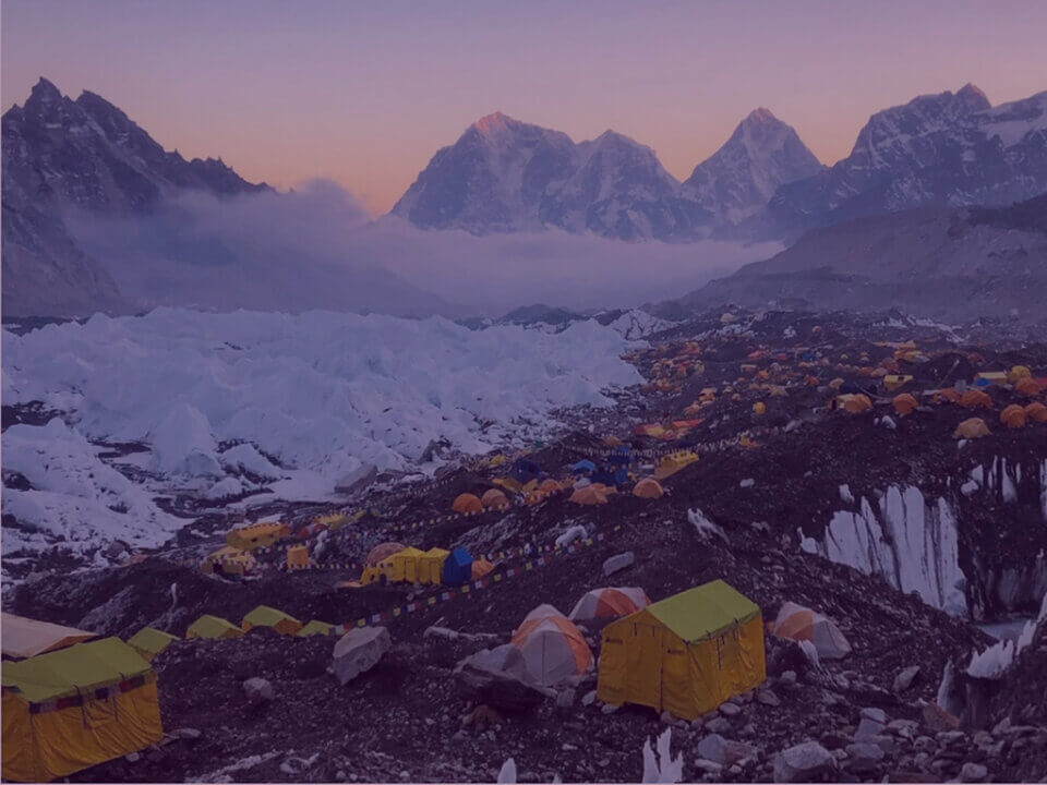 High-altitude base camp tents at sunrise, illustrating Andy Banks’ Light Fund charity challenges.