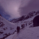 Fundraisers hiking through snowy mountain landscape in support of The Light Fund charity challenge