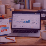 Amazon FBM seller managing peak season orders on laptop with fulfilment supplies and July Prime Day calendar