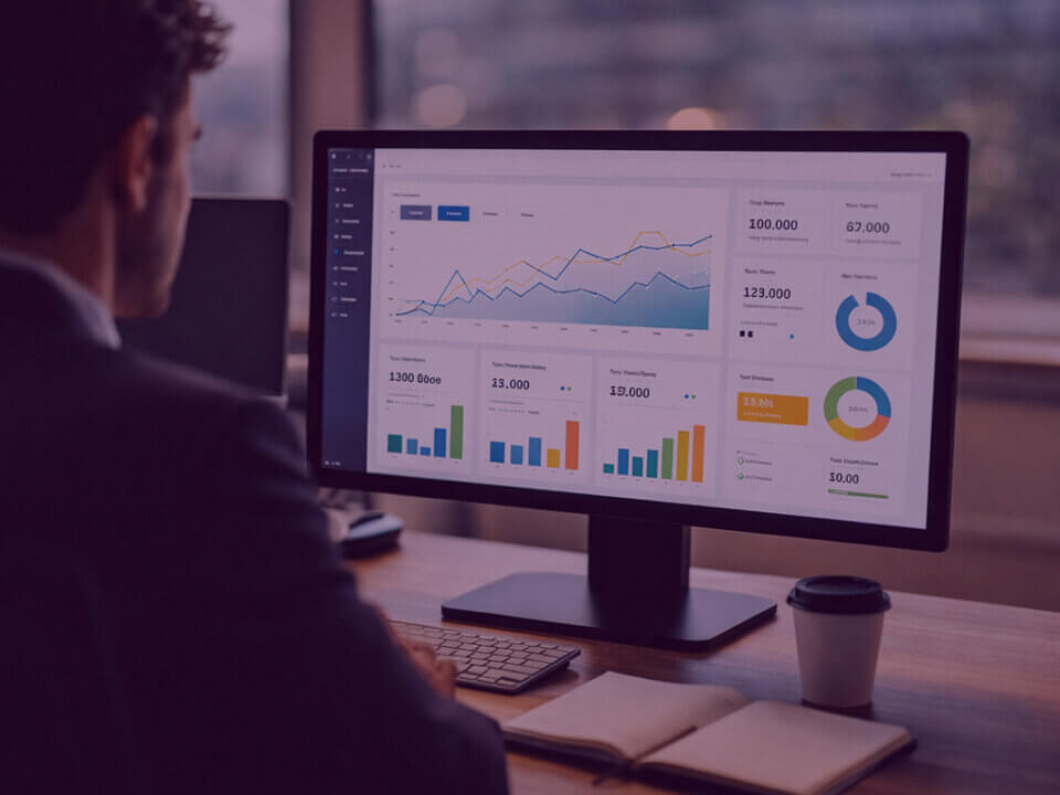 Amazon Interactive Canvas Experience Dashboard - Venture Forge Business professional viewing a performance dashboard on a desktop monitor in a modern office workspace